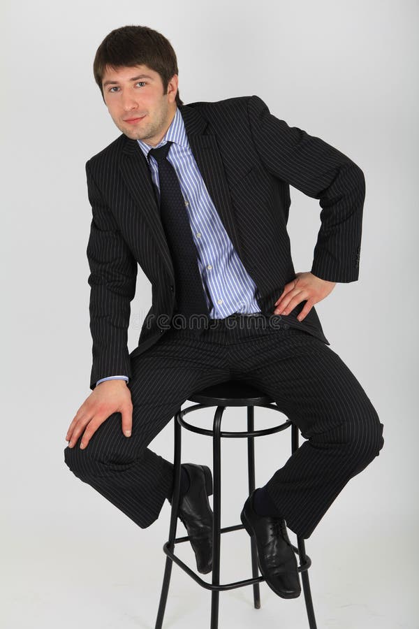 Man in business suit sitting on a chair