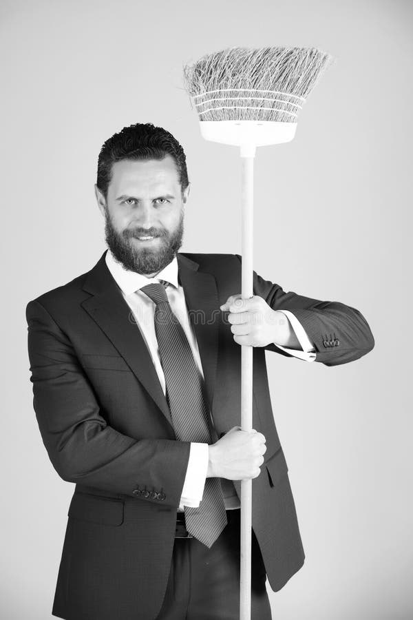Man or businessman with happy face, broom in business outfit royalty free stock image Man or businessman with happy face, broom in business outfit royalty free stock image