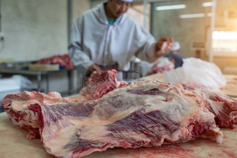 The man butcher cutting raw beef stock photos The man butcher cutting raw beef stock photos