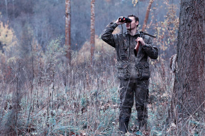 Man in Camouflage and with Guns in a Forest Belt on a Spring Hun Stock ...