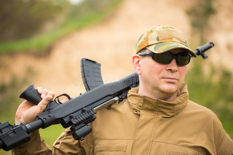 Man in camouflage with a shotgun