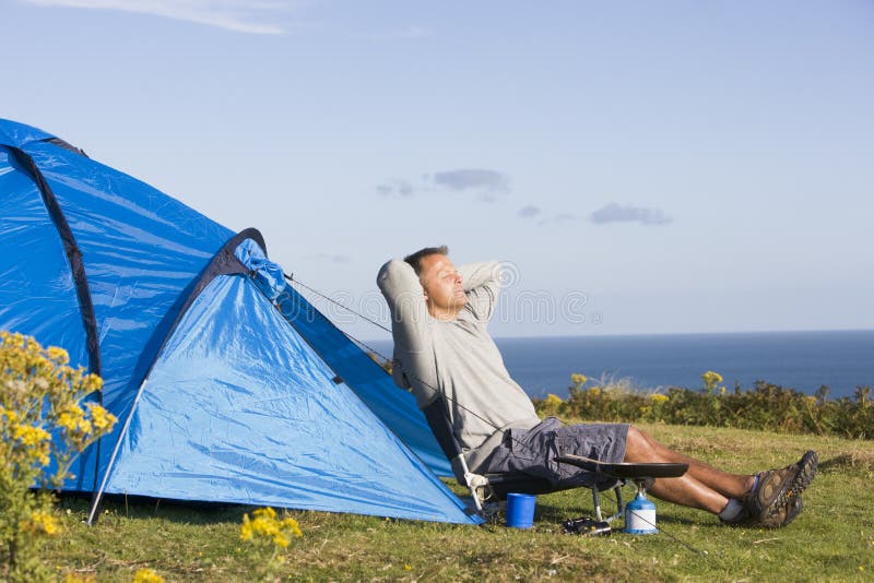 Man Camping Outdoors and Cooking Stock Photo Image of adult, holiday