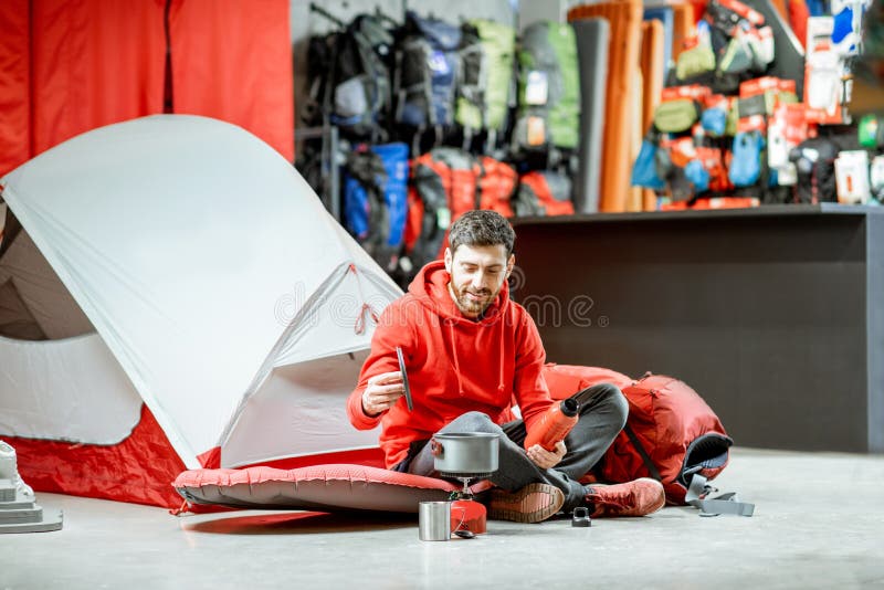 Man with Camping Tools and Tent in the Shop Stock Photo - Image of ...