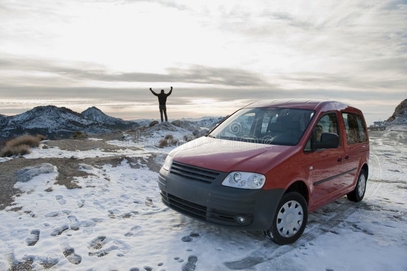 Man standing in snowed landscape with his car. Man standing in snowed landscape with his car