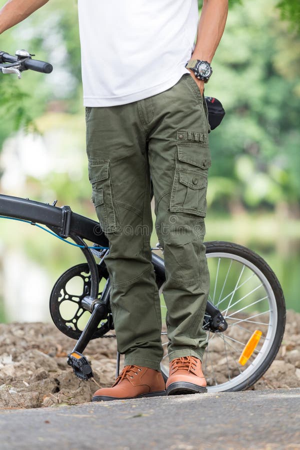 Man with Cargo Pants Riding a Bicycle in the Garden Stock Photo Image
