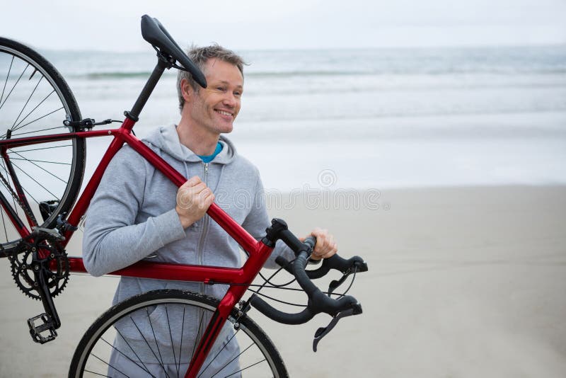Man Carrying Bicycle on Beach Stock Photo Image of routine, energetic