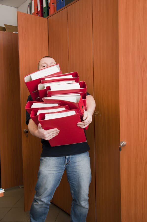 White man carrying the binders