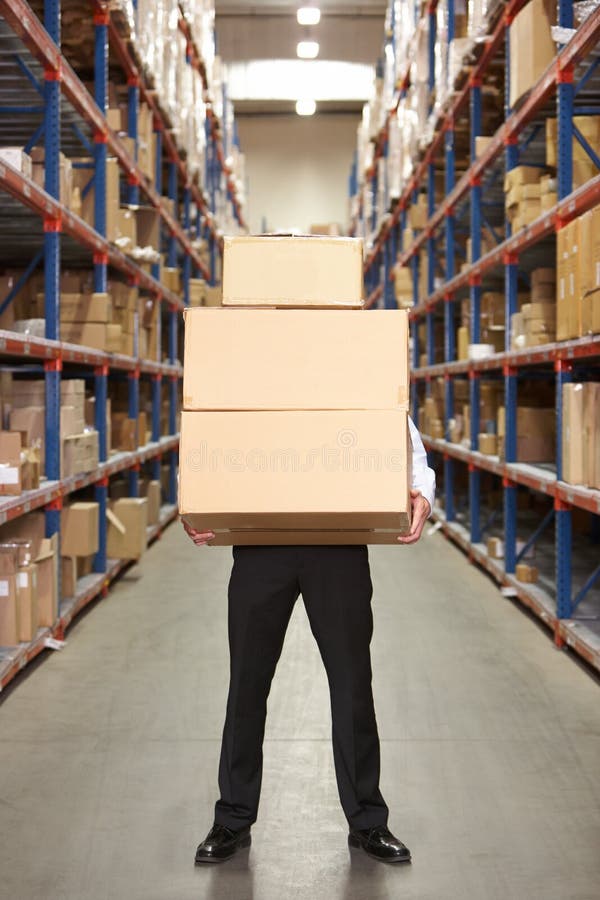 Man Carrying Boxes In Warehouse stock photography
