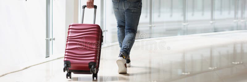 A Man Carrying a Suitcase at the Airport Terminal Stock Photo Image