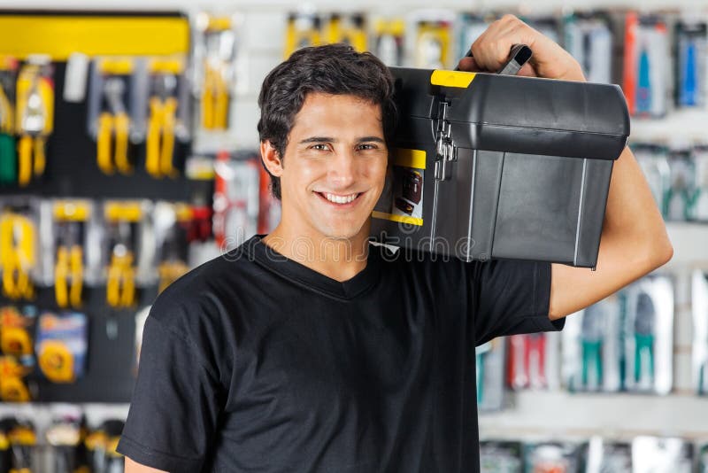 Man Carrying Toolbox On Shoulder In Hardware Store