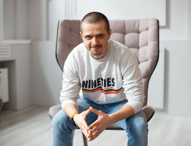 Man in Casual Wear Sitting in Chair Indoor Stock Photo - Image of ...