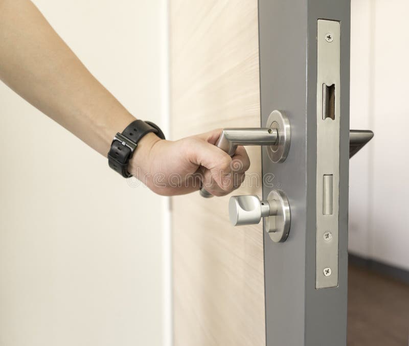 Man catch Door Handles stainless steel on door wood to open royalty free stock photos Man catch Door Handles stainless steel on door wood to open royalty free stock photos