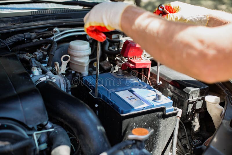 Man Changes a Car Battery. Car Repair and Maintenance Stock Image