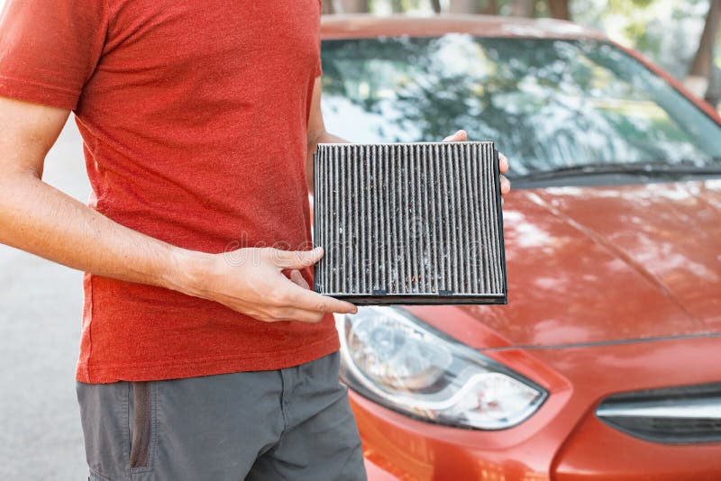Change old polluted filter for the ventilation of the car interior. Dangerous particles of pollen, bacteria and viruses are stock image