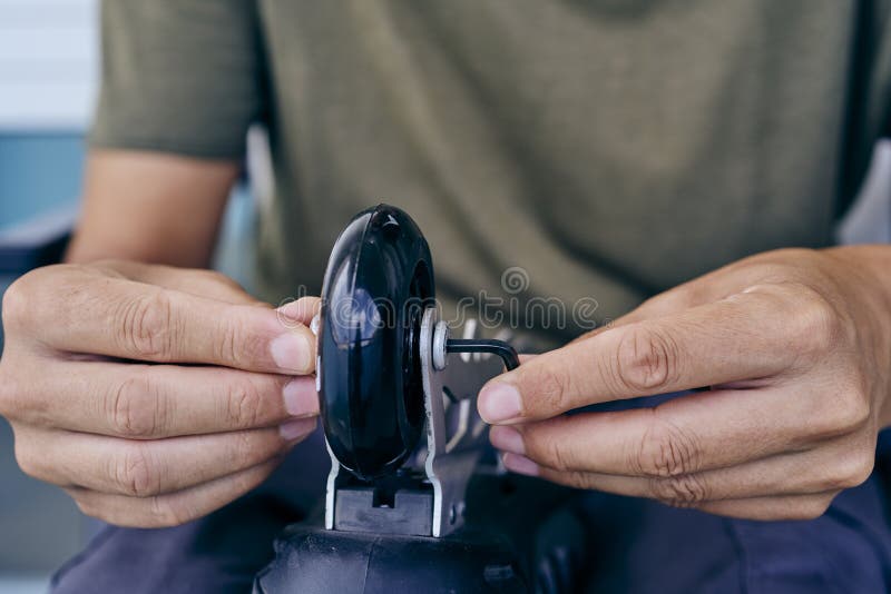Man Changing the Wheels of an Inline Skate Stock Photo Image of