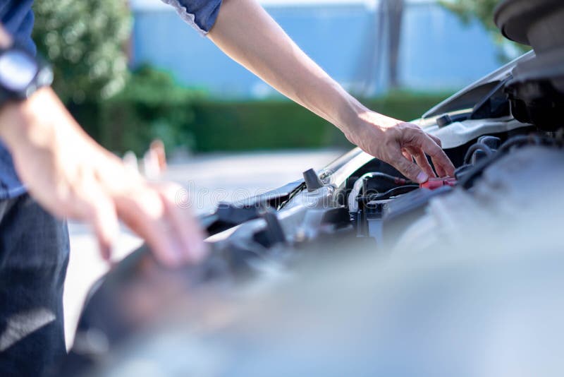 A Man Checking Car Engine, Check and Maintenance the Battery in Car