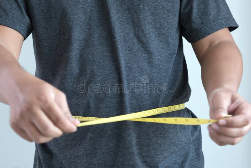 Man Checking Waistline body shape waist measure tape royalty free stock images