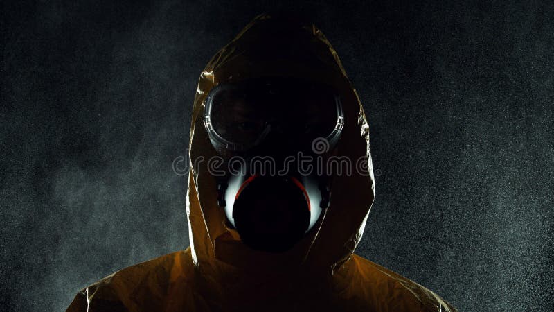 Man in chemical suit with respirator and goggles. Portrait of a man in chemical suit with respirator and goggles. Concept of protection against viruses stock photography Man in chemical suit with respirator and goggles. Portrait of a man in chemical suit with respirator and goggles. Concept of protection against viruses stock photography