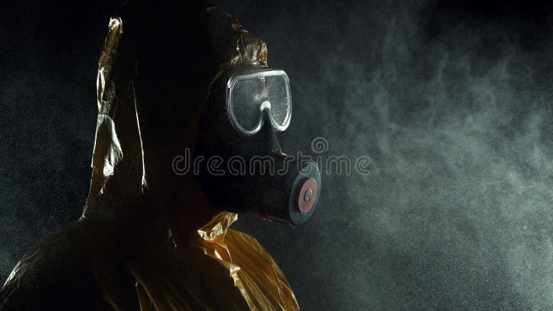 Man in chemical suit with respirator and goggles. Portrait of a man in chemical suit with respirator and goggles. Concept of protection against viruses stock image Man in chemical suit with respirator and goggles. Portrait of a man in chemical suit with respirator and goggles. Concept of protection against viruses stock image