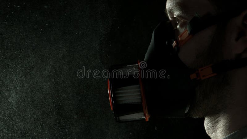 Man in chemical suit with respirator and goggles. Portrait of a man with respirator. Concept of protection against viruses, biological attack or chemical stock photo Man in chemical suit with respirator and goggles. Portrait of a man with respirator. Concept of protection against viruses, biological attack or chemical stock photo
