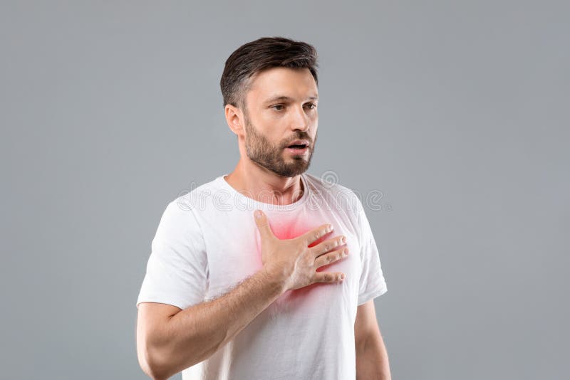 Man with Chest Pain Touching Inflammated Zone, Grey Background Stock