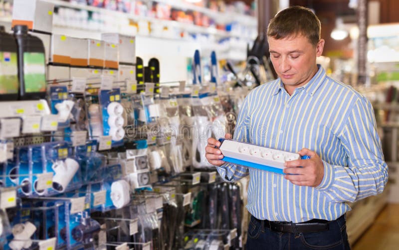 Man Chooses Electrical Parts in Store Stock Image Image of