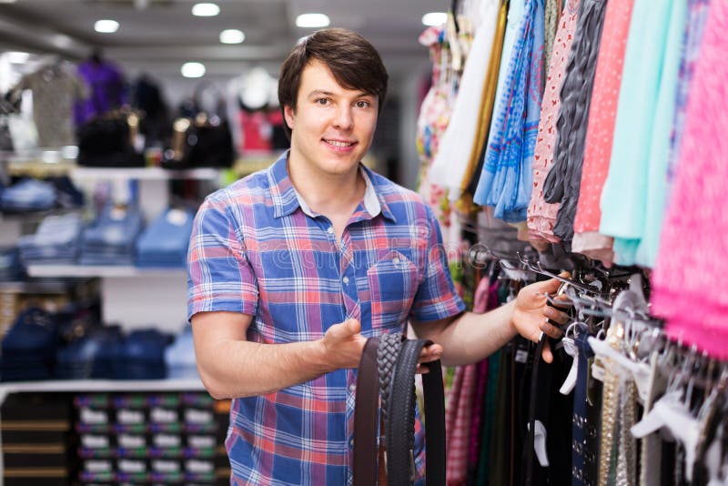 Man choosing belts in shop stock photo. Image of accessory - 63155490