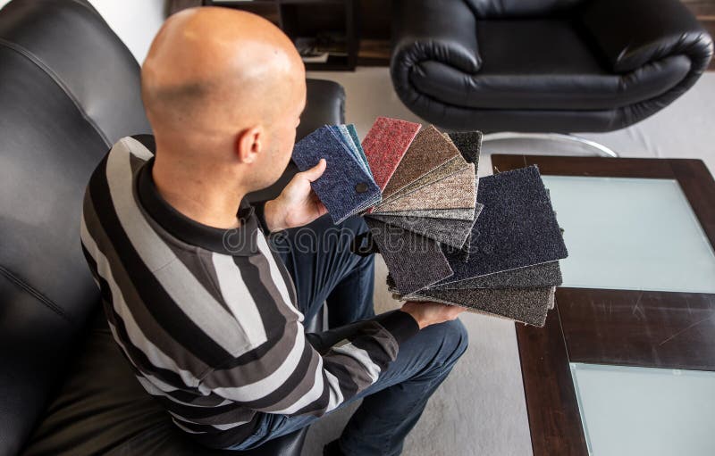 Man Choosing Flooring for His New Apartment, a Floor Selection Stock