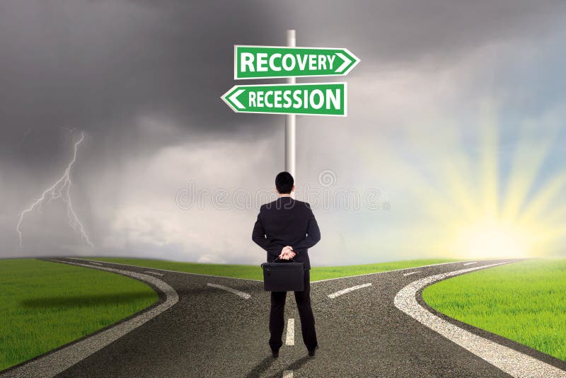 Man choosing the road to recovery or recession finance