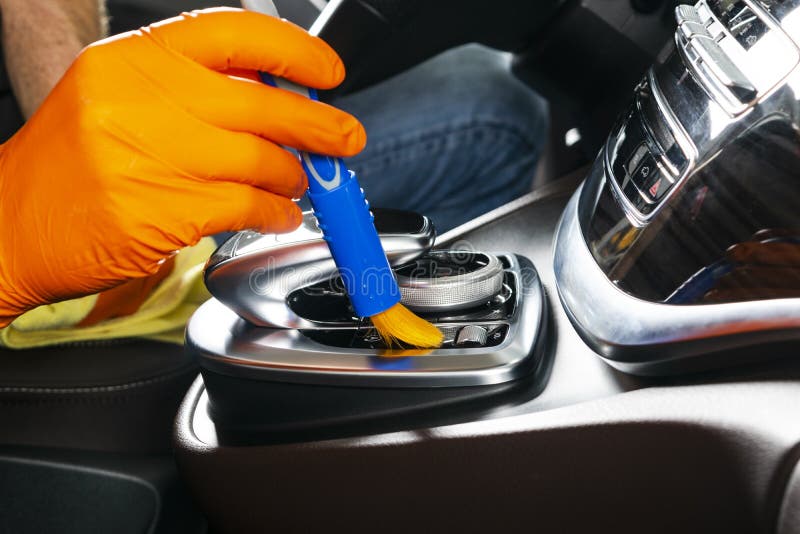 A Man Cleaning Car with Cloth and Brush. Car Detailing. Selective Focus