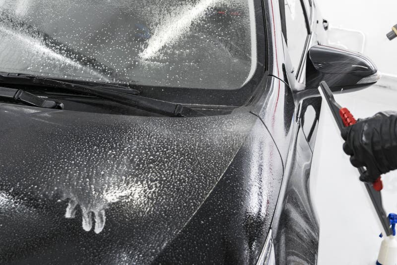 A Man Cleaning Car Engine with Shampoo and Brush. Car Detailing or