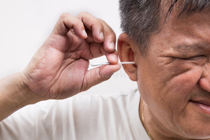 Man Cleaning Ear with Cotton Buds Stick with Ticklish Expression Stock
