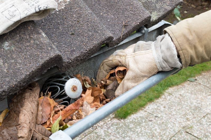 Man is cleaning the gutter royalty free stock images
