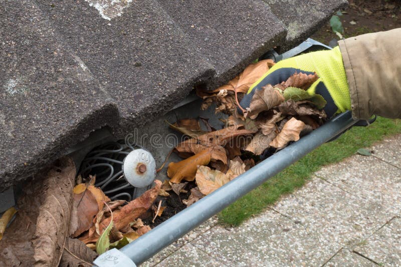 Man is cleaning the gutter stock photography