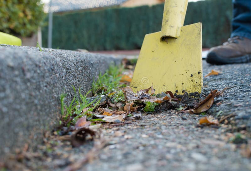 Man is cleaning the gutter royalty free stock image