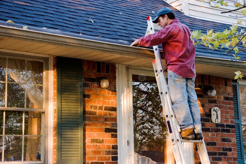 Man Cleaning Gutters stock image