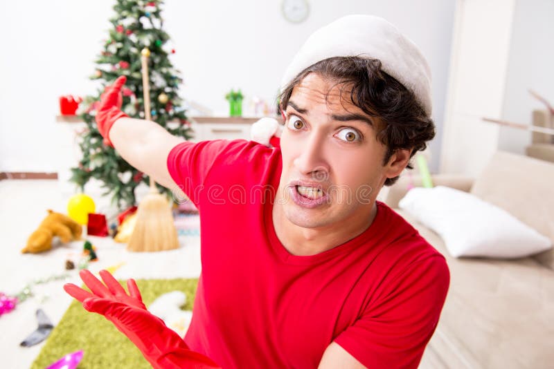 The man cleaning his apartment after christmas party