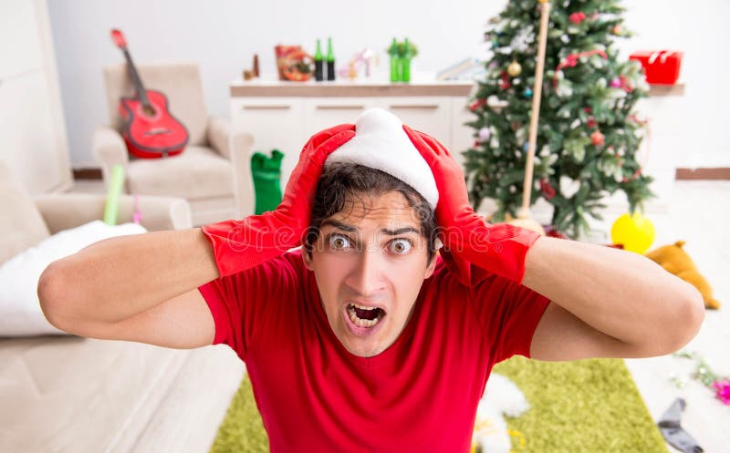 Man cleaning his apartment after christmas party