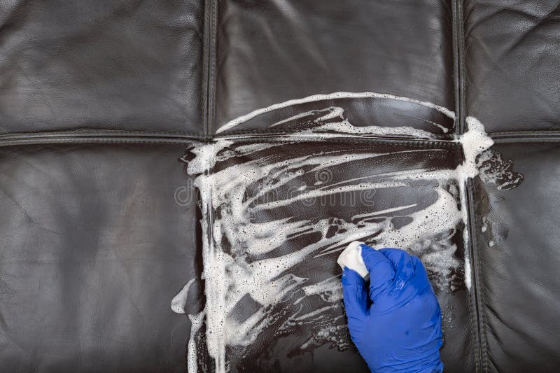 Man Cleaning Leather Sofa with a Soapy Cleaning Sponge Stock Image