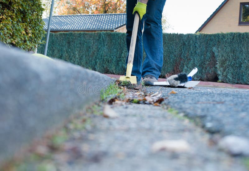 Man is cleaning the gutter royalty free stock photography