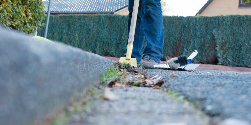 Man is cleaning the gutter stock image