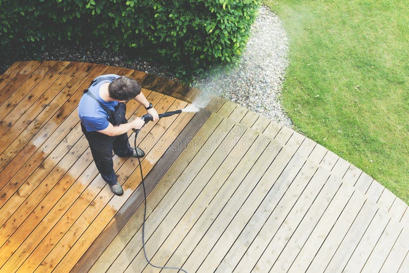 Cleaning terrace with a power washer - high water pressure clean