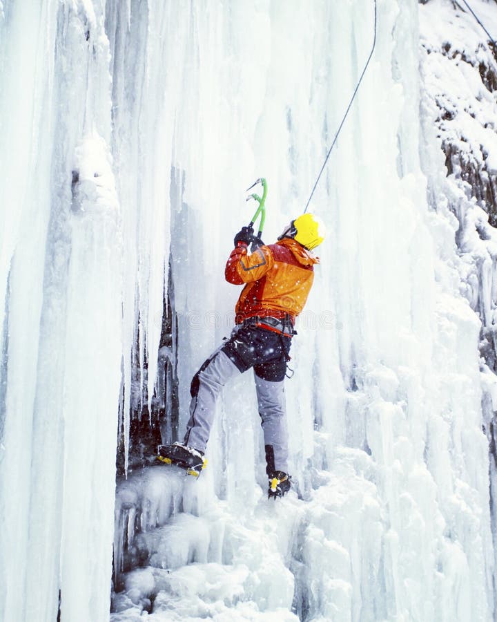 Man climbing frozen waterfall. stock image Man climbing frozen waterfall. stock image