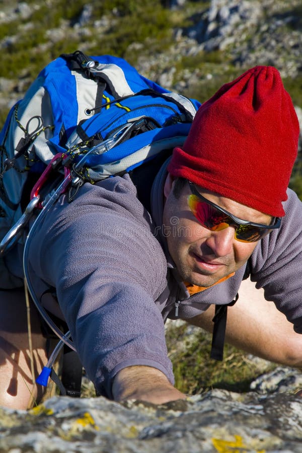 Man climbing a mountain stock image. Image of adventure 10961455