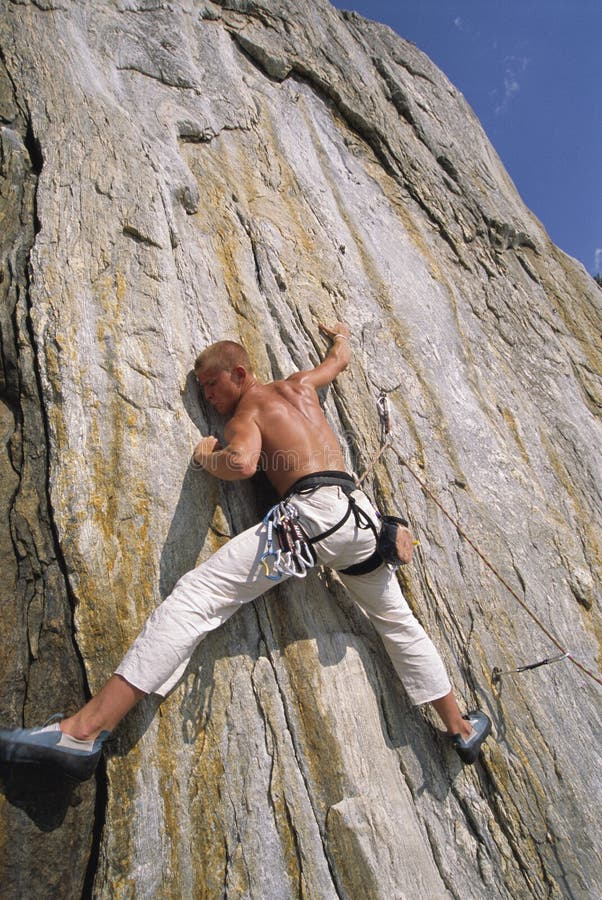 A man climbing a rock face royalty free stock images A man climbing a rock face royalty free stock images