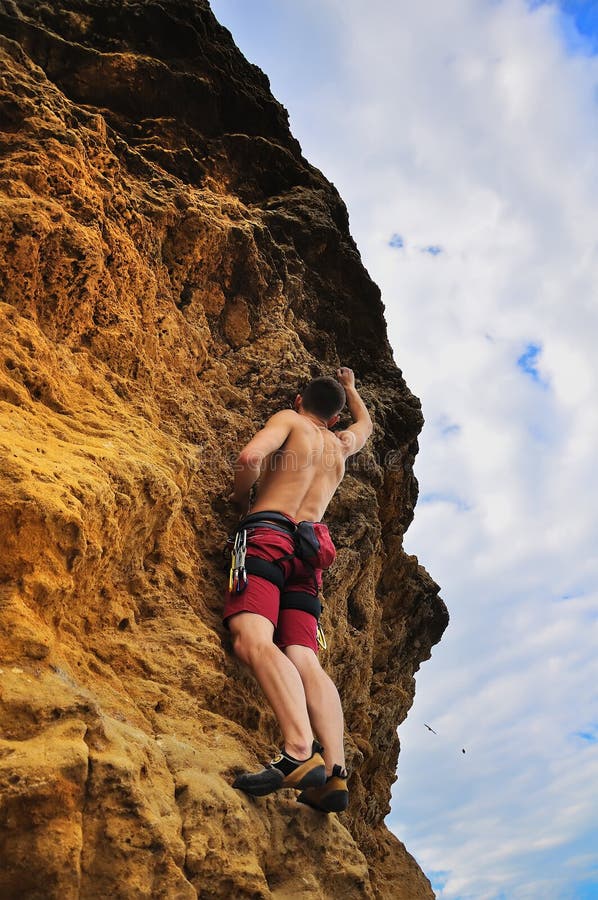 Man climbing on rock stock photo. Image of evening, activity 42250956