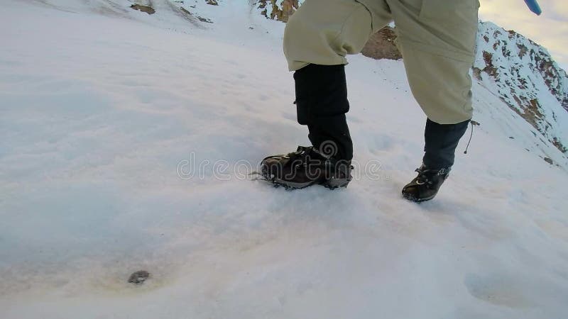 Man Climbing Up Snowy Mountain Ice Axe and Crampons stock footage