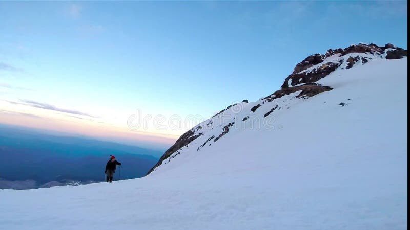 Man Climbing Up Snowy Mountain Ice Axe and Crampons stock footage