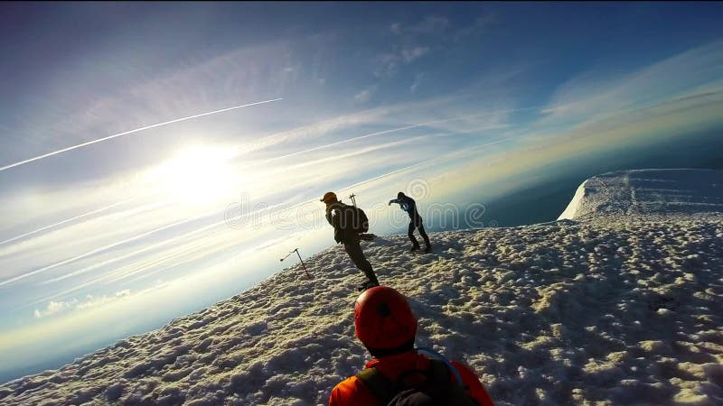 Man Climbing Up Snowy Mountain Ice Axe and Crampons stock footage
