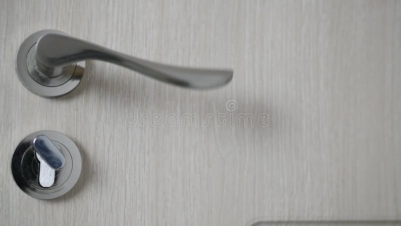 Man Closing a Wooden Door from the Office Locking It with the Key